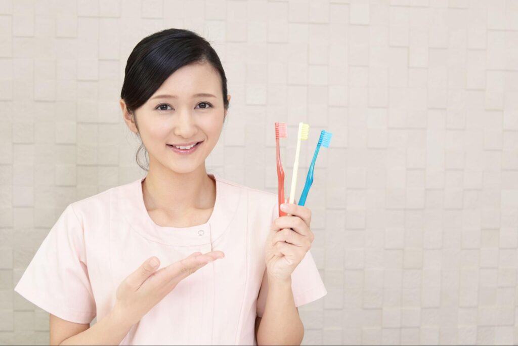 歯ブラシを持った歯科医療従事者の女性