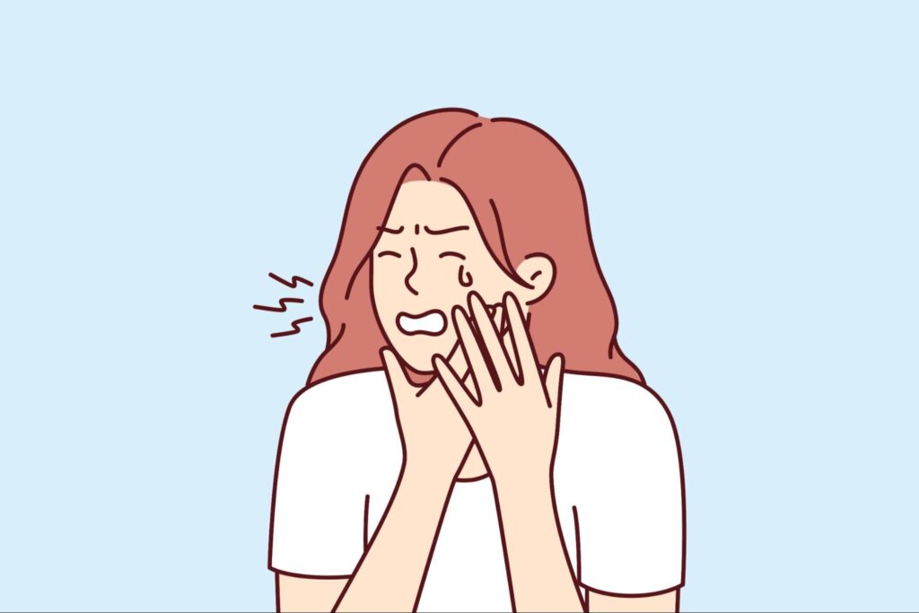 歯が痛くて頬を押さえる女性のイラスト